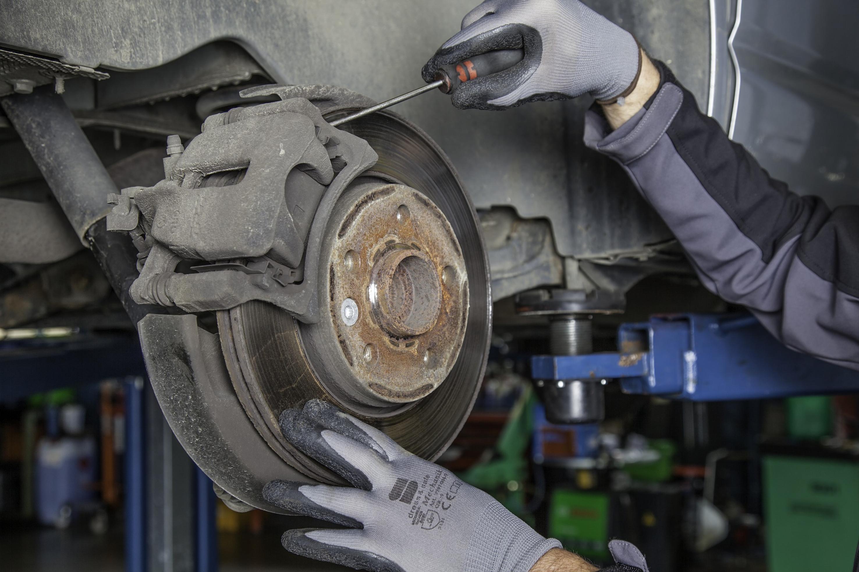 Image of car suspension with brake rotor exposed.